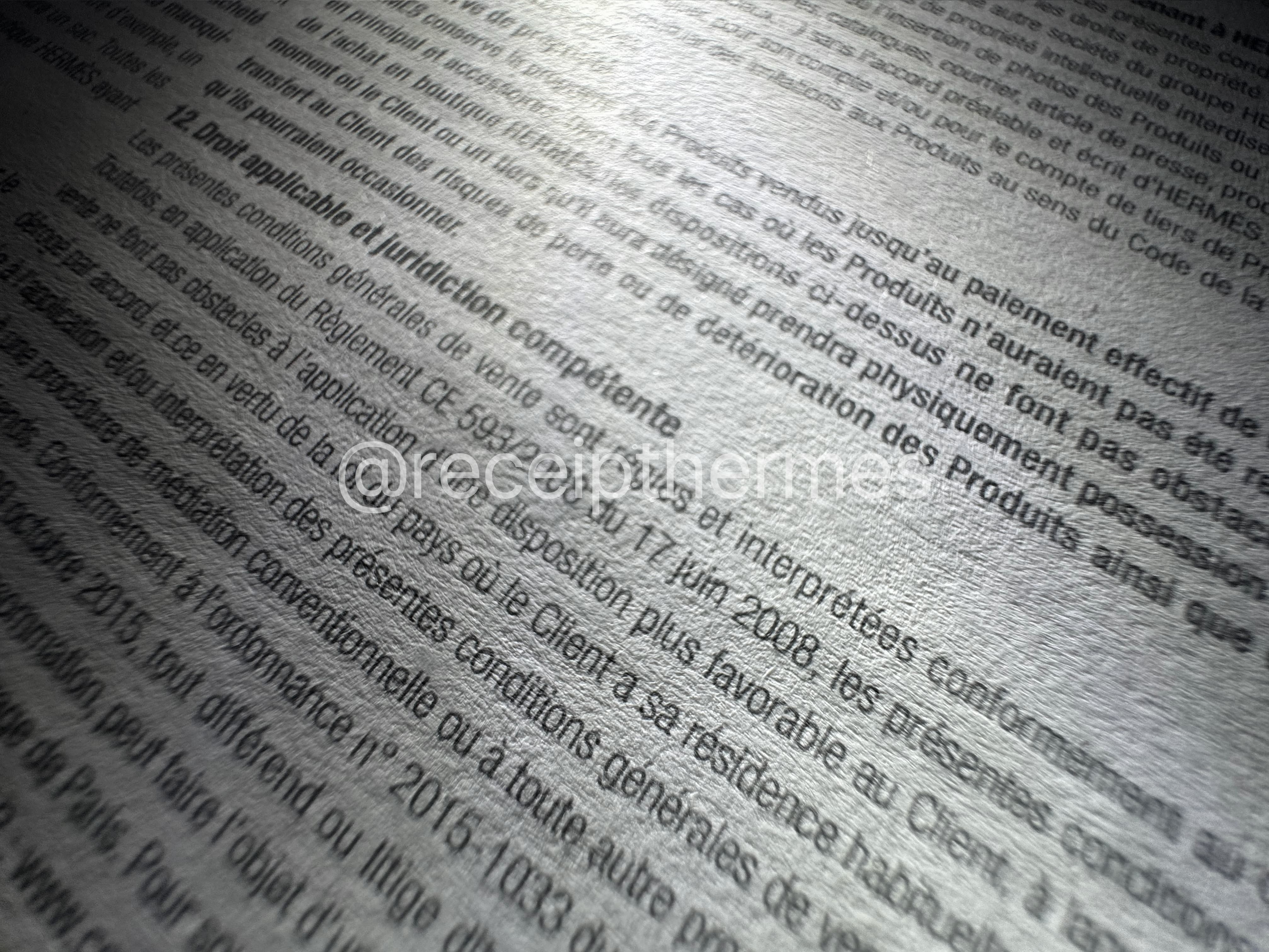Replacement Hermes receipt back side closeup — legal clauses and fine print text with correct typography