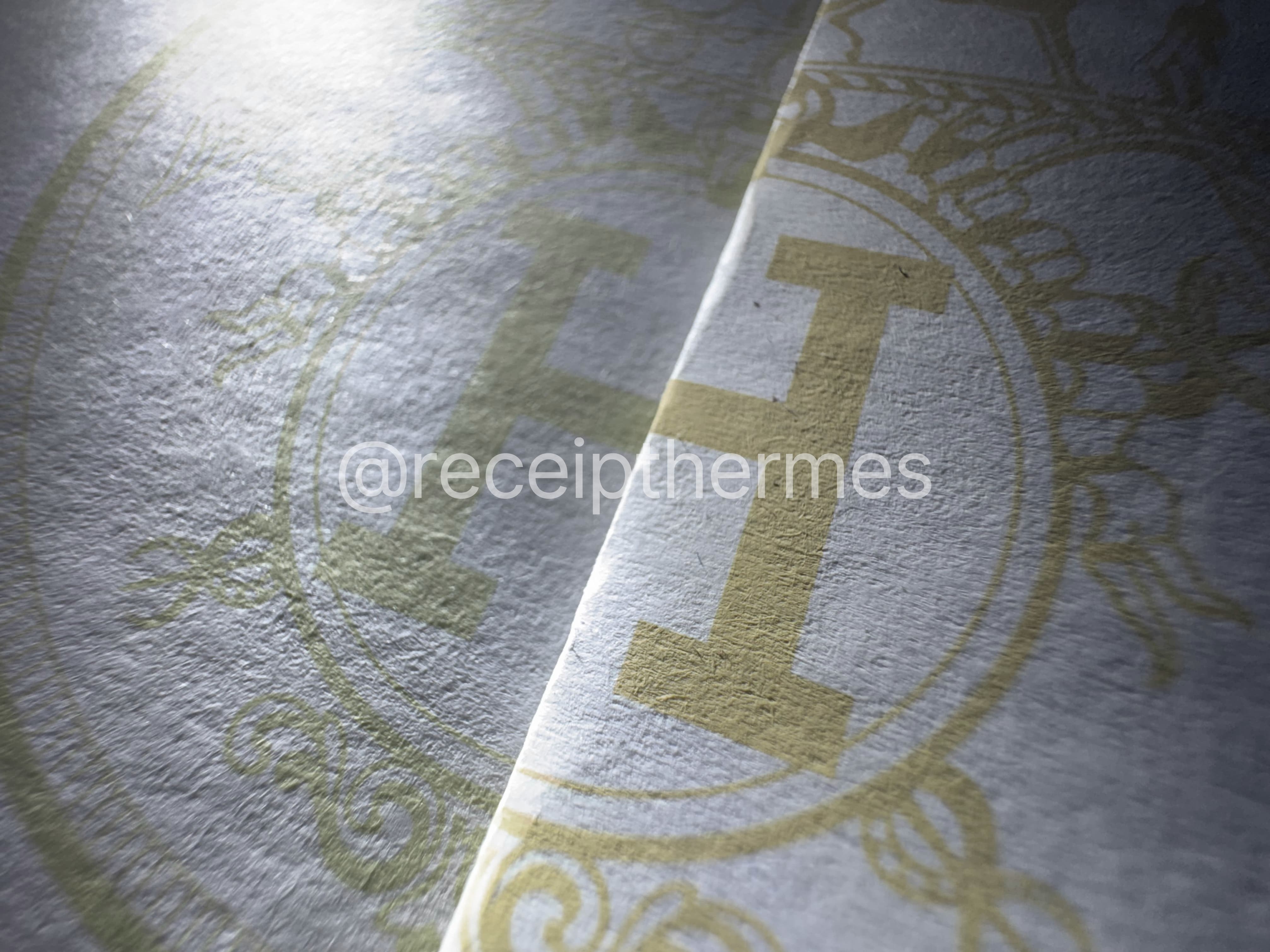 Side-by-side comparison of Premium (left) vs Standard (right) Hermes receipt — center logo and paper quality from a second angle